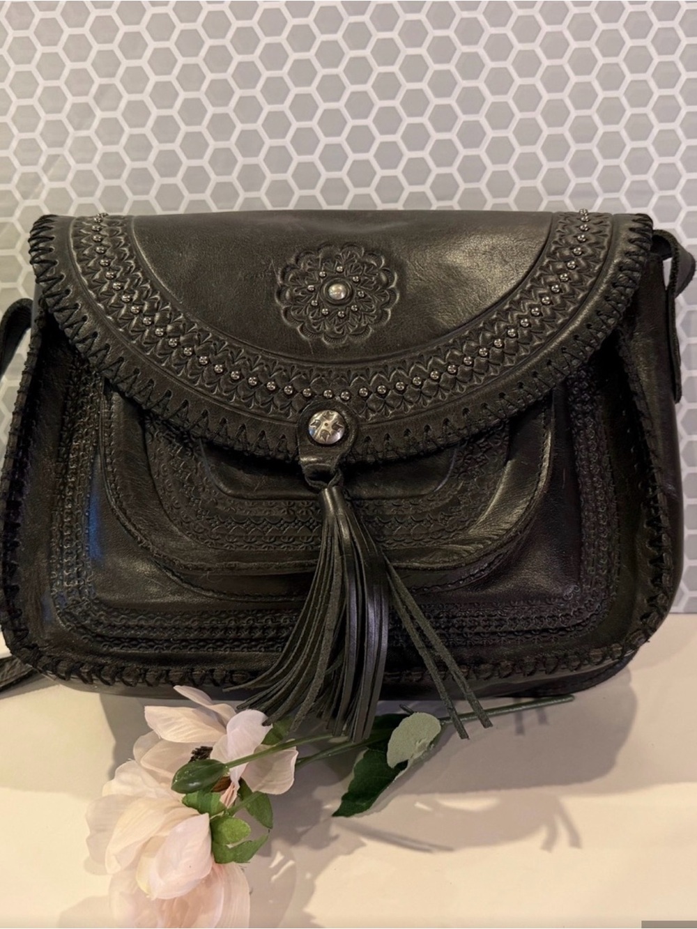 Hand-Tooled Black Leather Crossbody Bag with Tassel